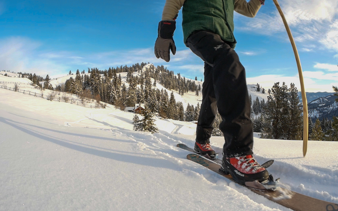 Alpina Boots A bluebird sunny day showing a person skiing down a hill wearing the Alpina boots