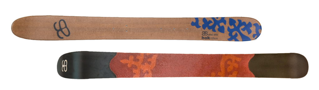 Hoks 125 cm pair with one ski turned over to show the skin on the bottom